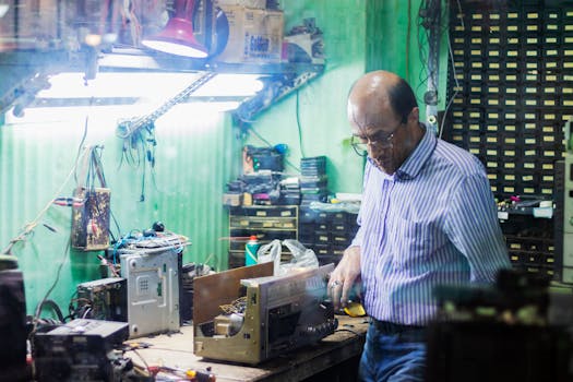 image of an electrician working on a circuit board